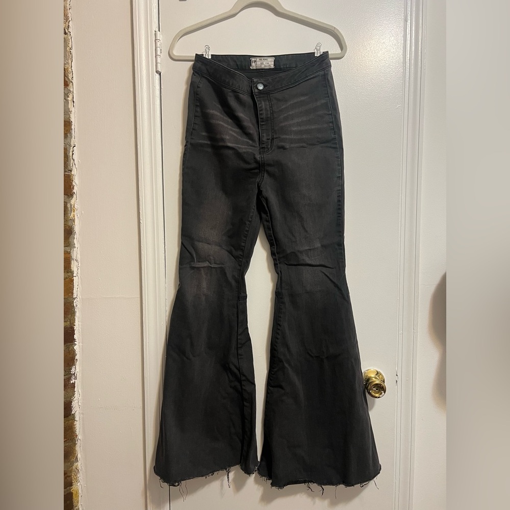 Black high waisted Free People bootcut jeans with raw hem.